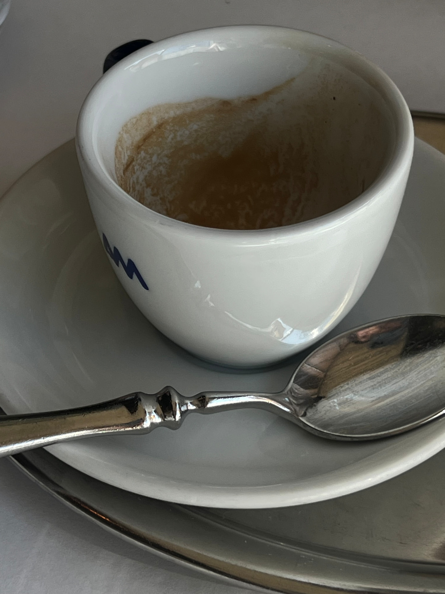 An empty espresso cup and spoon